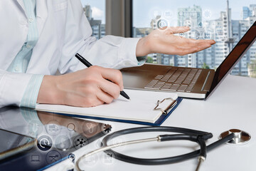 Doctor points to a computer monitor working .