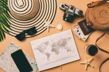 Top view travel concept with retro camera films, map and passport on light orange background with copy space. Flat lay tourist essentials