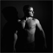 © alberto - a muscular man with shadows