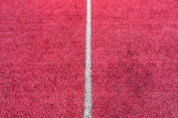 Wall Mural - Pink synthetic grass sports field with white line shot from above. Soccer, rugby, football, baseball sport concept