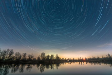Wall Mural - Star trails over the quarry lake Silbersee near Speyer in Germany.