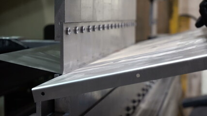 CNC bending machine. The machine bends the metal part