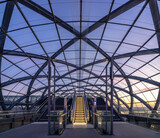 Fototapeta Miasto - Modern train station glas roof and escalator at blue hour