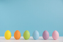 Colorful Eggs On Light Blue Background. Happy Easter Background. Minimal Easter. Rainbow Color
