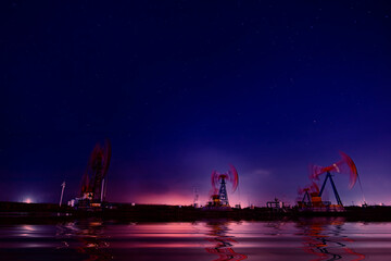 Wall Mural - Oil pumping machinery in operation, crude oil extraction scene in the night, North China