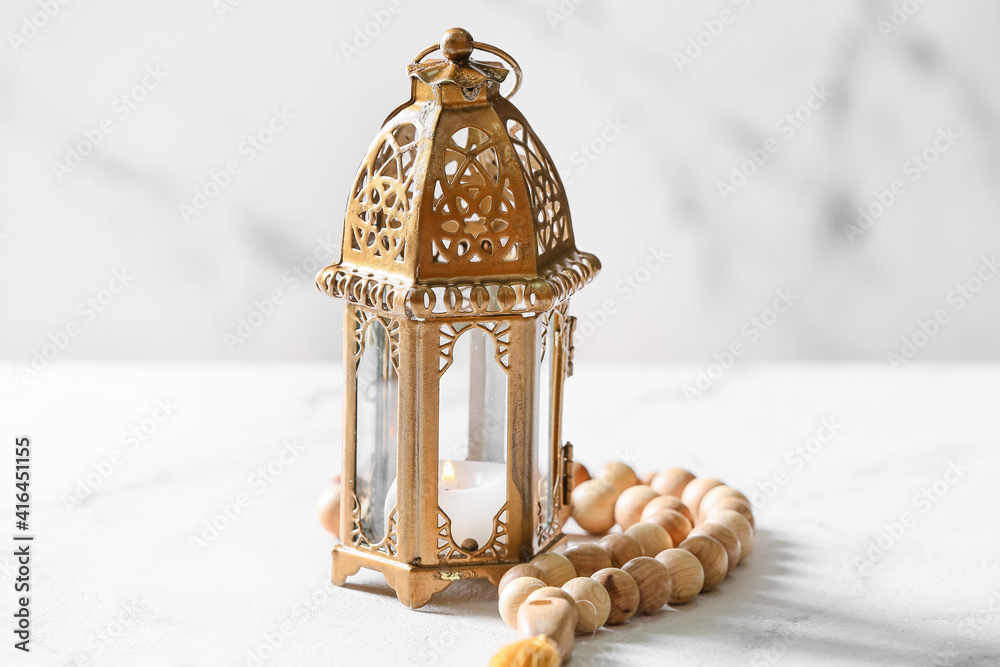 Muslim lamp and tasbih on white background