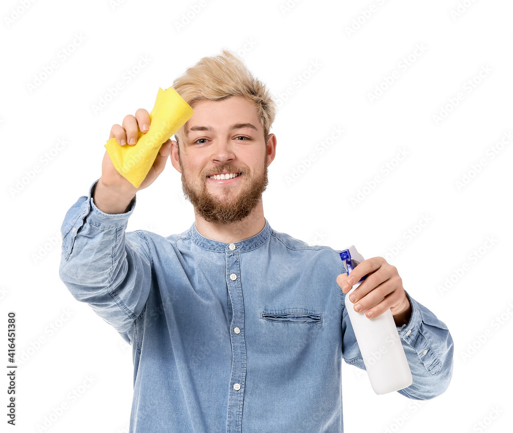 Young man with cleaning supplies on white background
