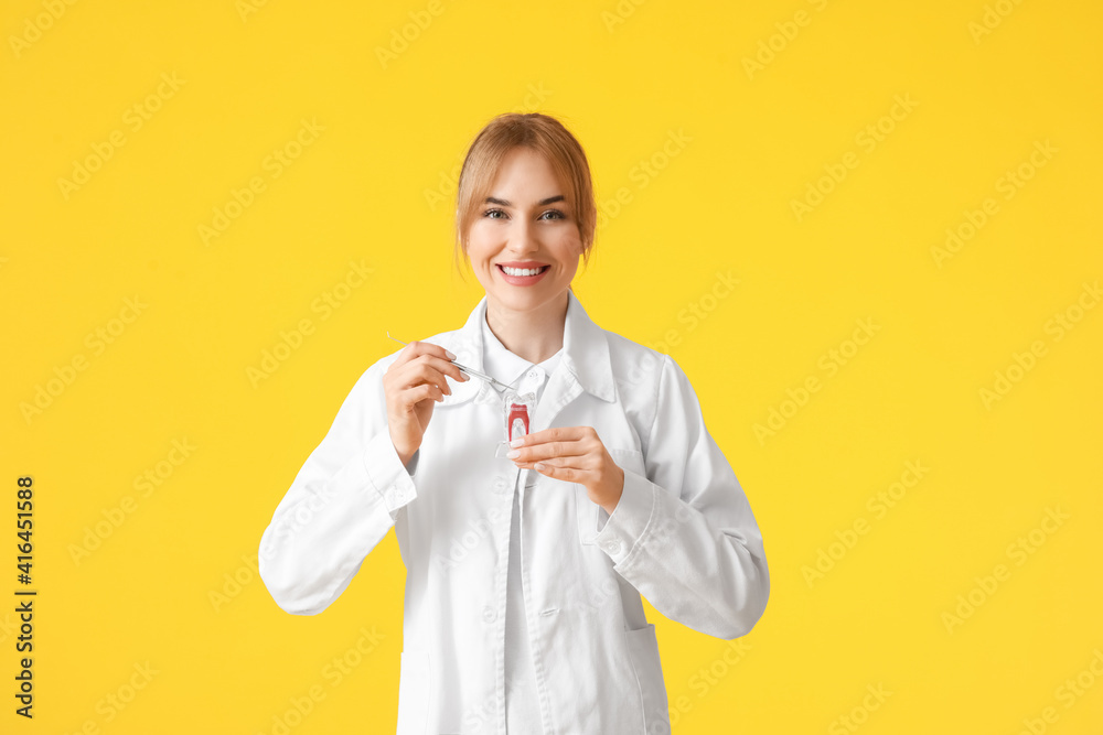 Female dentist on color background
