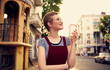 © SHOTPRIME STUDIO - pretty woman with short hair and red lips on the street walk glass with drink