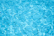 Bright blue water ripple with sparkles and water waves refraction. Abstract image from swimming pool water surface.