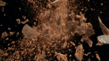 Poster - Super slow motion of falling group of raw chocolate pieces on black background. Filmed on high speed cinema camera, 1000fps.