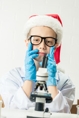 student learning chemistry. positive joyful smart boy testing and using a microscope in science clas
