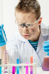 Wall Mural - funny boy dressed as chemist with dirty face after a failed experiment