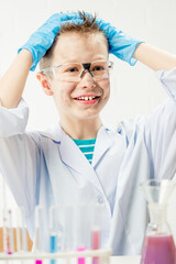 Wall Mural - funny boy dressed as chemist with dirty face after a failed experiment