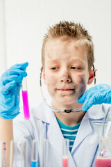 Wall Mural - funny boy dressed as chemist with dirty face after a failed experiment