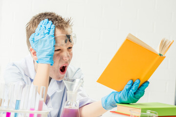 Wall Mural - funny boy dressed as chemist with dirty face after a failed experiment