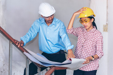 Construction engineer teamwork Safety Suit Trust Team Holding White Yellow Safety hard hat Security Equipment on Construction Site. Hardhat Protect Head for Civil Construction Engineer Concept