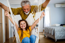 Happy Grandparent Having Fun Times With Kid At Home