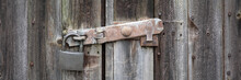 Panorama Close  Up View Of Old Rusty Clasp And Padlock On Wooden Door