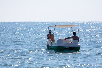 A man and a girl swim in the sea