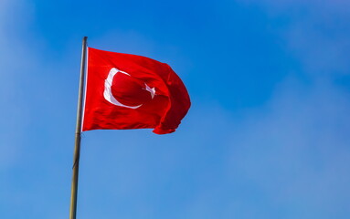 Turkish Flag on a blue sky background.