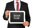 A Businessman holding slate mini blackboard with message Book Club