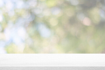 Wall Mural - abstract white wooden table with beautiful bokeh in the garden background.