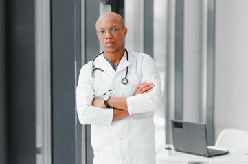 Wall Mural - African American man male hospital doctor in white coat with stethoscope