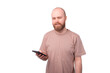 photo of man with beard holding smartphone and looking at the camera over white background