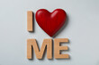canvas print picture - Phrase I Love Me made of wooden letters and red heart on light background, flat lay