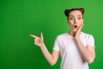 Poster - Portrait of pretty amazed funny girl demonstrating copy space wow new offer isolated over vibrant green color background