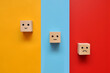 Wooden cubes with drawings of various human emotions: Sadness,  calmness, joy on multi-colored backgrounds 