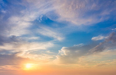 Wall Mural - gentle colors of real sundown sunset sky with beautiful light clouds and sun