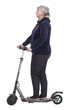© ASDF - elderly woman with an electric scooter looking at a white screen.