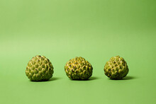 Sugar Apple Or Custard Apple, Ripe Exotic Tropical Fruit With Unique Skin Scales, Healthy Food, Vegetarian Diet And Nutrition. 3 Sugar Apple Isolated On Green Background. Fruit Is Rich In Vitamins