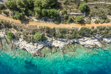 Wall Mural - Aerial drone shot of road by Adriatic coastline on Vis Island in Croatia summer time