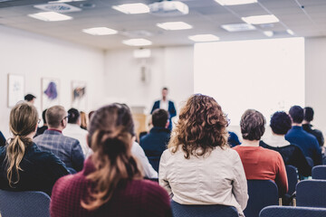 Wall Mural - speaker giving a talk at business meeting. audience in the conference hall. business and entrepreneu