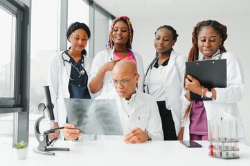 Wall Mural - confident african medical doctor and colleagues portrait in hospital