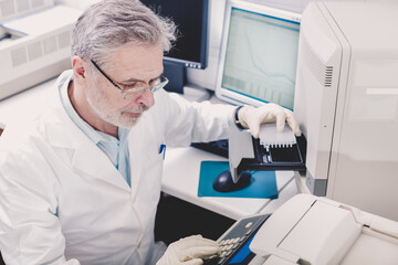 life science researcher performing a genotyping testing which enables personalized medicine. pm is a
