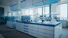 Modern Medical Research Laboratory With Computer, Microscope, Glassware With Biochemicals On The Desk. Scientific Lab Biotechnology Development Center Full Of High-Tech Equipment.