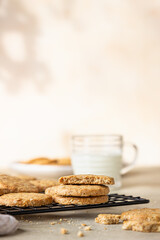 Wall Mural - Healthy oatmeal cookies with cereals, seeds and nuts with a cup of milk on concrete background. Diet vegan cookies.