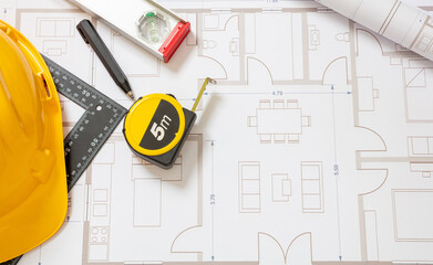 Wall Mural - Construction concept. Residential building drawings and hardhat on an office desk