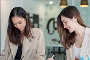 Wall Mural - Young Asian businesswoman happy working at the office.