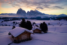 Wood Cabins Covered With Snow With Sassopiatto And Sassolungo In Background At Dawn, Seiser Alm, Dolomites, South Tyrol, Italy, Europe