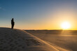 © robertharding - Tuareg standing on a sand dune in the Tenere Desert at sunrise, Sahara, Niger, Africa