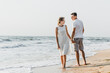 © Vadym - beautiful loving couple walks on the seashore. happy young couple spend time on the beach. honeymoon newlyweds. guy with girl at dawn of the day. couple on vacation. summer rest. couple hugging