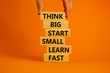 © Dzmitry - Think big start small symbol. Words 'Think big start small learn fast' on wooden blocks on a beautiful orange background. Businessman hand. Business, motivational and think big start small concept.