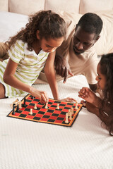 Father and small daughters having fun while playing