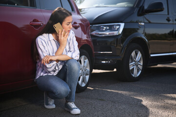 Wall Mural - Stressed woman talking on phone after car accident outdoors