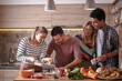 © BalanceFormCreative - Fiends preparing vegetarian meal.They preparing food and making fun in the kitchen.Home party.